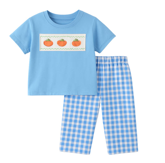 Children's blue shirt with pumpkin design and checkered pants on a light gray background
