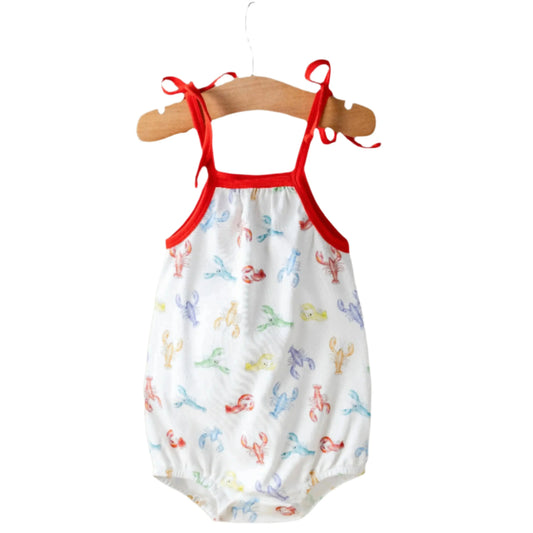 Baby romper with red straps on a hanger against a white background