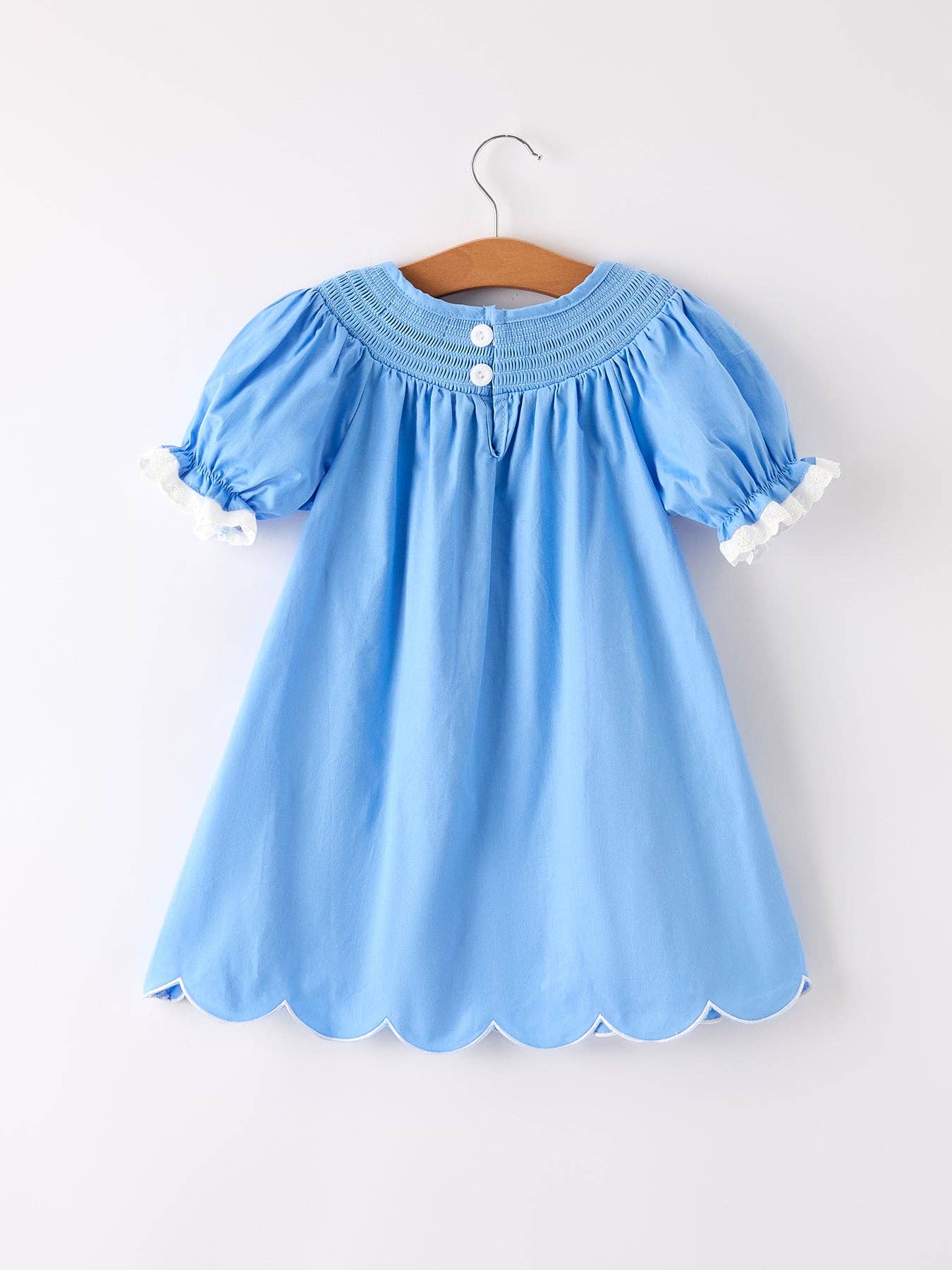 Light blue dress with scalloped hem on a white background