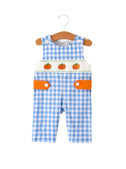 Blue checkered baby romper with orange pumpkins on a hanger against a white background